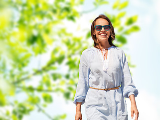 Image showing happy smiling woman over green natural background