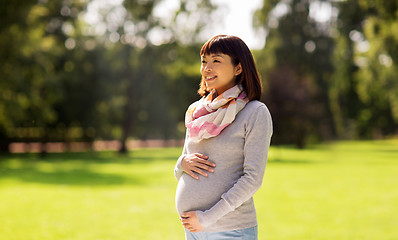 Image showing happy pregnant asian woman at park