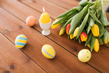 Image showing candle in shape of easter egg and tulip flowers