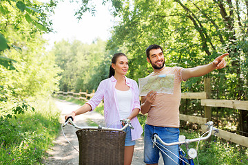 Image showing couple with map and bicycles at country in summer