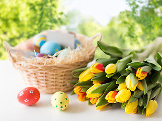 Image showing close up of colored easter eggs and tulip flowers