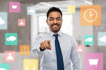 Image showing businessman pointing to you or app icons at office