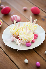 Image showing cupcakes with easter eggs and candies on table