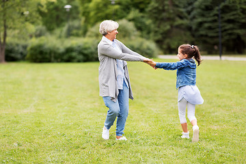 Image showing grandmother and granddaughter playing at park