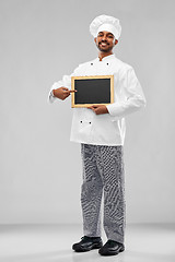 Image showing happy male indian chef in toque with chalkboard