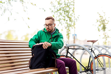 Image showing man or hipster with backpack on street bench