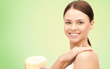 Image showing beautiful woman with moisturizing cream