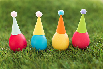 Image showing easter eggs in party hats on artificial grass