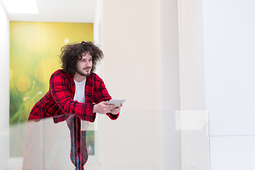 Image showing young freelancer using tablet computer