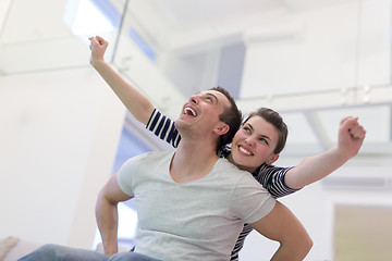 Image showing handsome man piggybacking his girlfriend