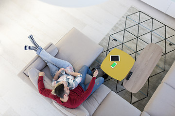 Image showing Young couple on the sofa watching television