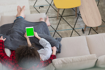 Image showing couple relaxing at  home with tablet computers