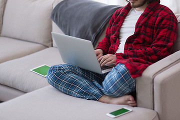 Image showing man freelancer in bathrobe working from home