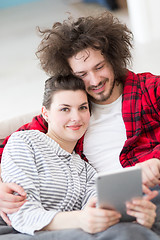 Image showing couple relaxing at  home with tablet computers