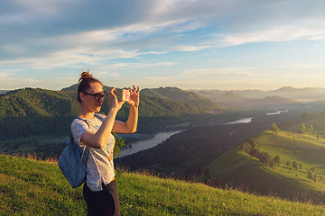 Image showing Woman taking photo in mountain