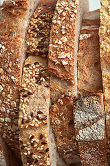 Image showing Macro photos of slices of homemade, grain bread with sesame seeds and flax. Organic Healthy Food. Flat lay