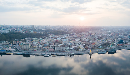 Image showing The panoramic bird\'s eye view shooting from drone of the Podol district, the right bank of the Dnieper River and centre of Kiev, Ukraine at summer sunset on the background of the cloudy sky.