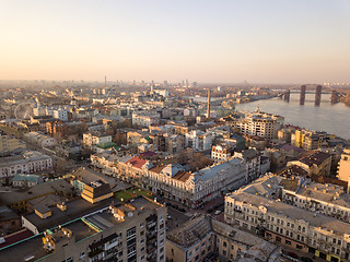 Image showing The panoramic bird\'s eye view from drone to the central historical part of the city Kiev - the Podol district, the Dnieper River in Kiev, Ukraine at summer sunset.