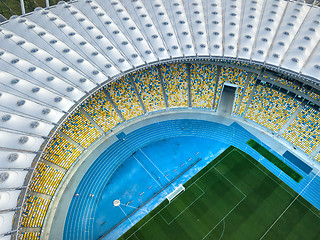 Image showing KYIV, UKRAINE - July 19, 2018. National Sports Complex Olympic NSC Olimpiysky. Aerial view from drone of construction of the stadium cover, green football field, tribunes.