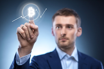 Image showing hand man Icon Bitcoin on virtual screen.