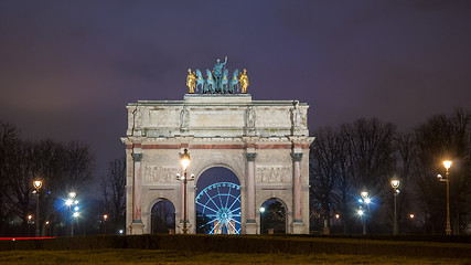 Image showing Paris, France - August 04, 2006: Beautiful view of the Arc de Triomphe du Carrousel in the evening against the backdrop of street lamps.