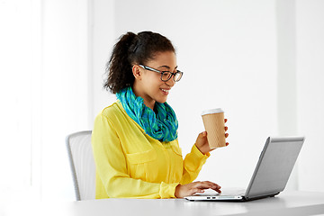 Image showing creative woman with coffee and laptop at office