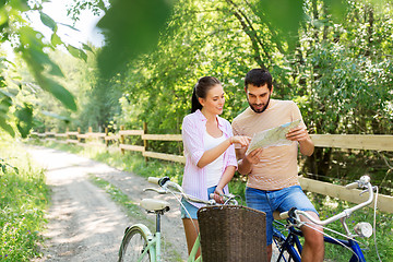 Image showing couple with map and bicycles at country in summer