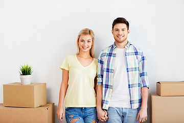 Image showing happy couple with boxes moving to new home