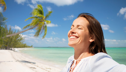 Image showing happy woman over tropical beach background