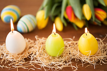 Image showing candles in shape of easter eggs and tulip flowers