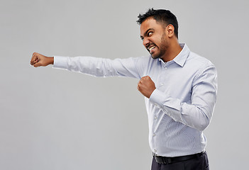 Image showing angry indian businessman fighting over grey