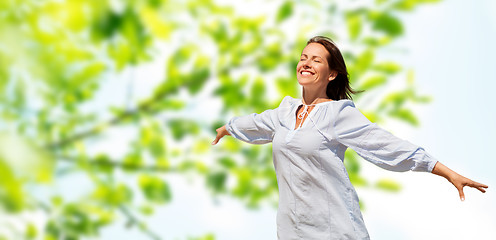 Image showing happy smiling woman over green natural background