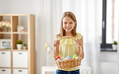 Image showing happy girl with basket of easter eggs at home