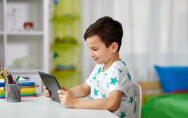 Image showing student boy with tablet pc and notebook at home