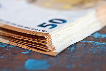 Image showing Currency bank notes stacked on rustic wooden table background cl