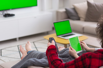 Image showing couple relaxing at  home with tablet computers