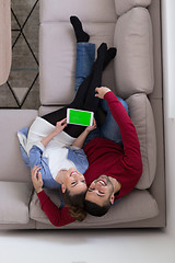 Image showing couple relaxing at  home with tablet computers