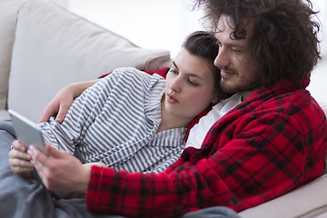 Image showing couple relaxing at  home with tablet computers