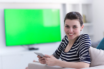 Image showing woman on sofa using tablet computer