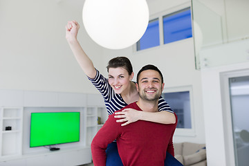 Image showing handsome man piggybacking his girlfriend