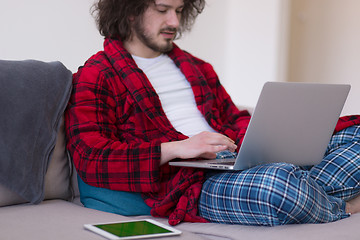 Image showing man freelancer in bathrobe working from home