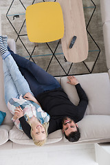 Image showing Young couple on the sofa watching television top view