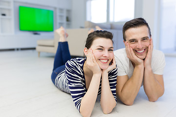 Image showing couple lying on the floor at home