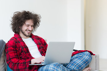 Image showing man freelancer in bathrobe working from home