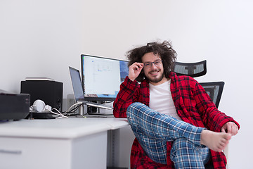 Image showing graphic designer in bathrobe working at home