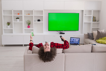 Image showing young man in bathrobe enjoying free time