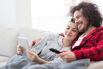 Image showing couple relaxing at  home with tablet computers