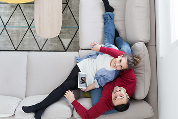 Image showing couple relaxing at  home with tablet computers