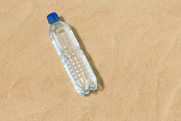 Image showing bottle of water on beach sand