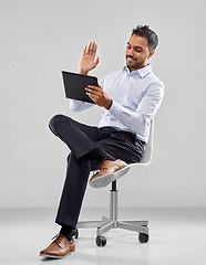Image showing indian businessman with tablet pc on office chair